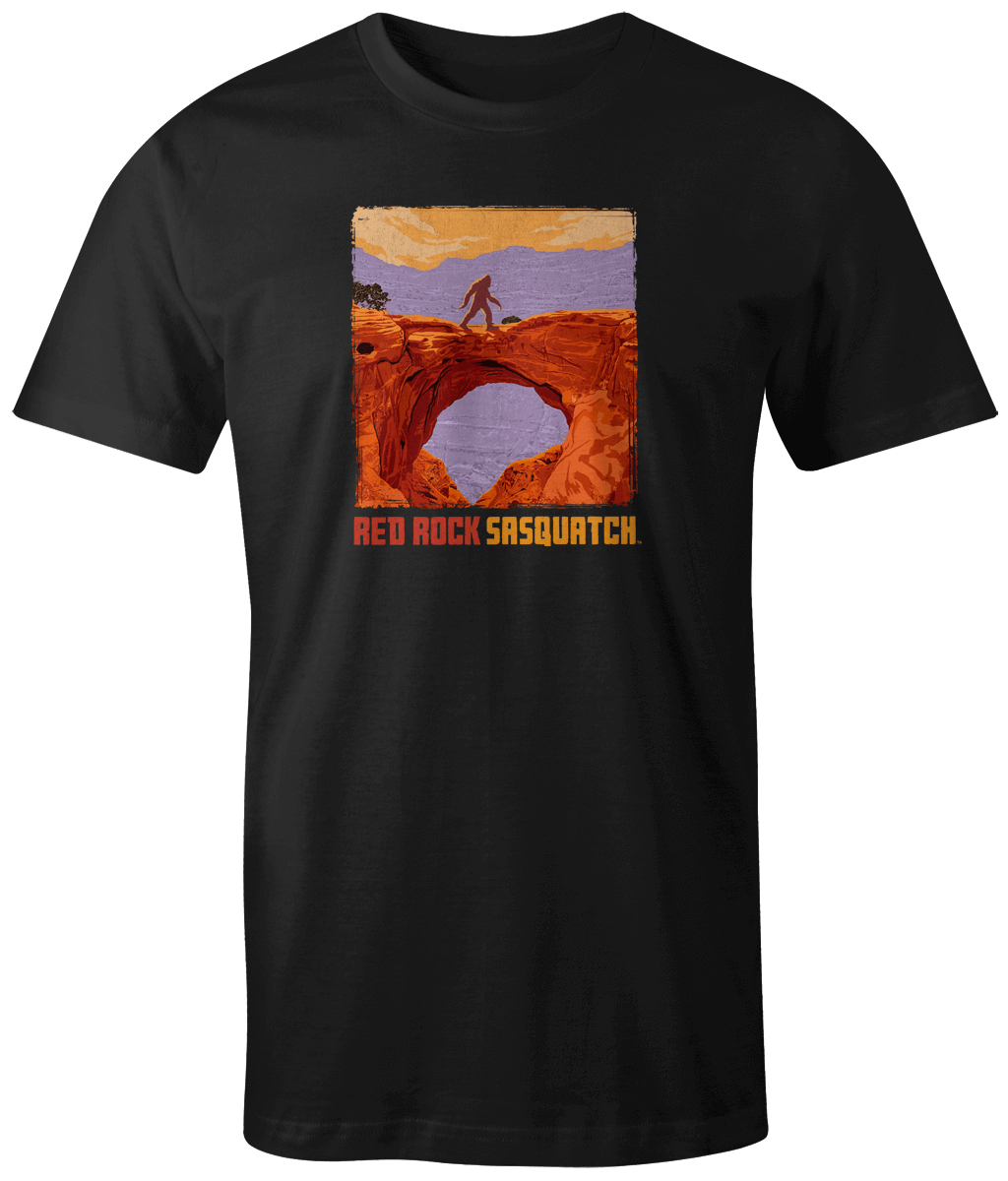 Black short-sleeve t-shirt featuring a Sasquatch standing on a natural bridge in Capitol Reef National Park.