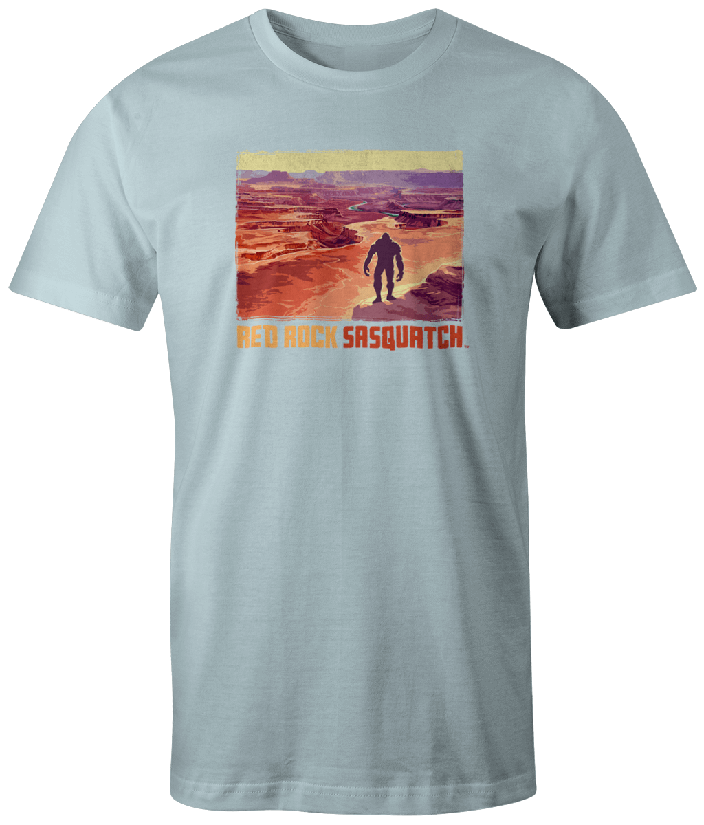 Chambray short-sleeve t-shirt showcasing a Sasquatch figure amidst the dramatic terrain of Canyonlands.