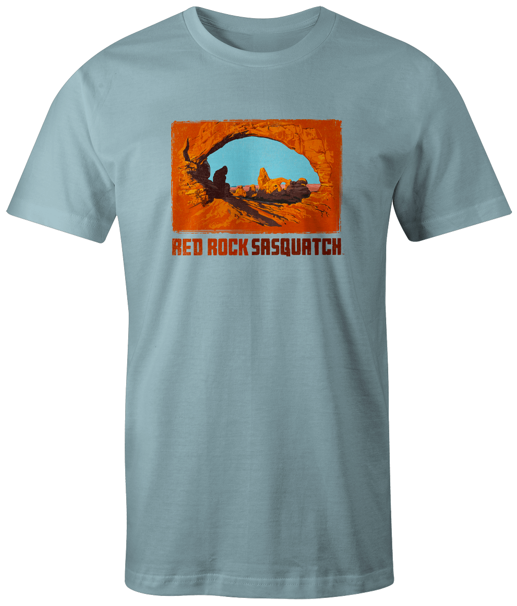 Chambray short-sleeve t-shirt showcasing a Sasquatch figure within the Delicate Arch formation.