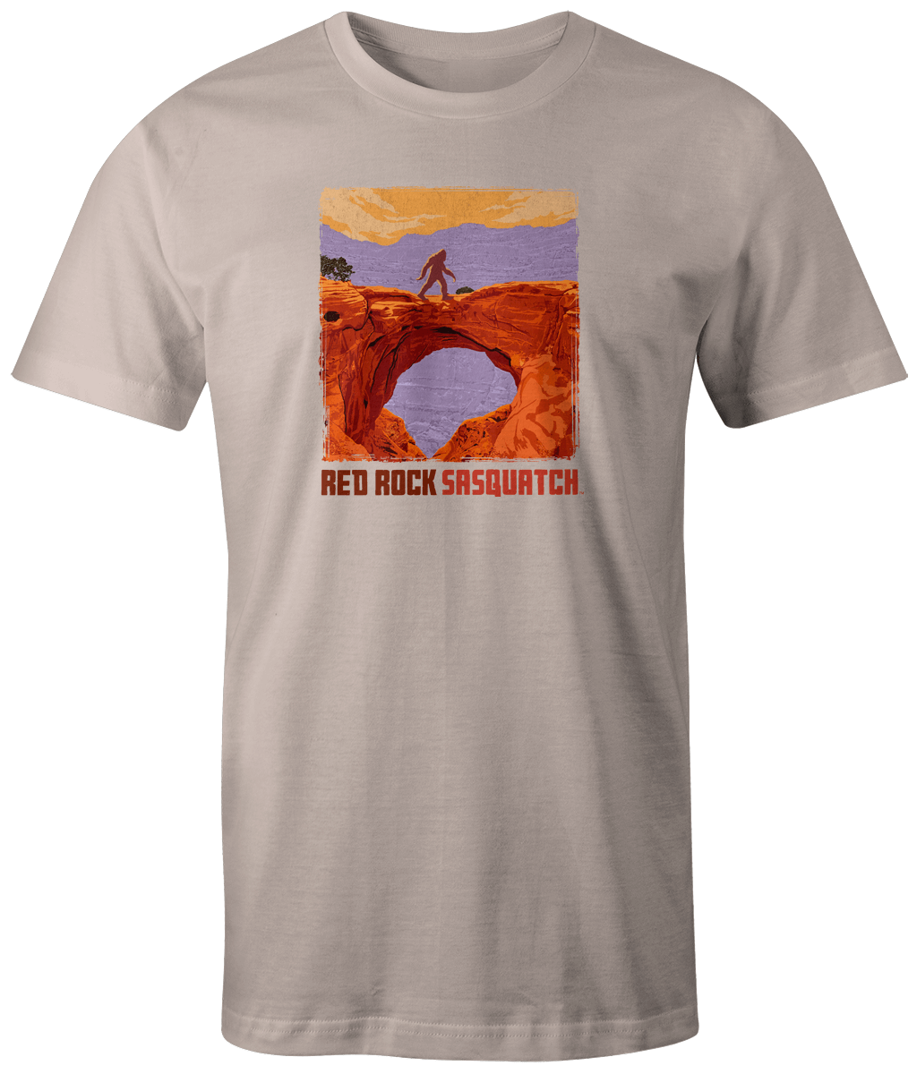 Ivory short-sleeve t-shirt displaying a Sasquatch within the rugged landscape of Capitol Reef National Park.