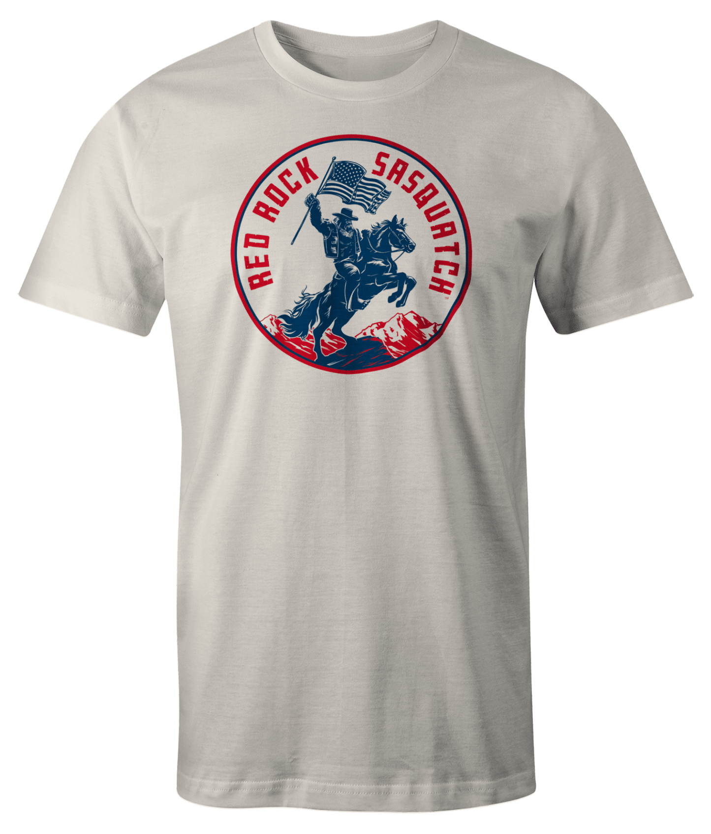 White Squatchrider t-shirt with red text. Features Sasquatch riding a horse and waving an American flag. A patriotic and unique design.