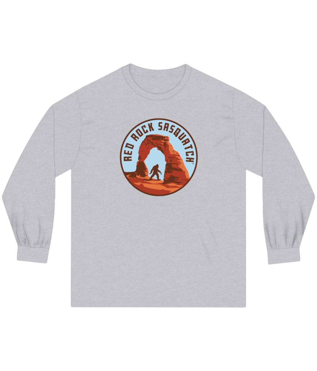 Athletic heather long-sleeve Delicate Arch tee. Features a Sasquatch silhouette at Delicate Arch in Arches National Park.