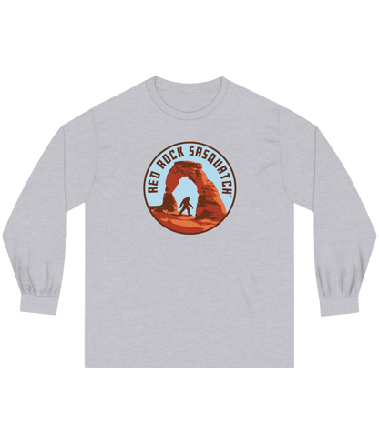 Athletic heather long-sleeve Delicate Arch tee. Features a Sasquatch silhouette at Delicate Arch in Arches National Park.