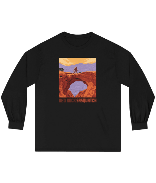 Black Capitol Reef Long-Sleeve Tee. Showcases a unique design of Sasquatch standing on a rock arch in Capitol Reef.