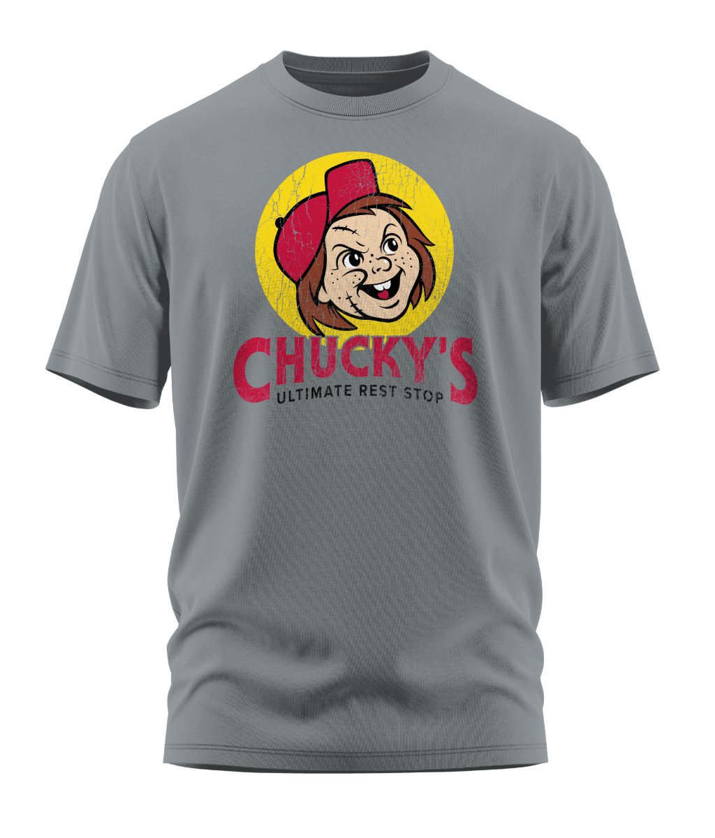 Front view of the light gray Chucky's Rest Stop Unisex T-Shirt from Shirts Of Legend. The graphic is a funny horror movie parody of the Buc-ee's logo, featuring a distressed illustration of Chucky's face in a red hat inside a yellow circle with the text "Chucky's Ultimate Rest Stop."