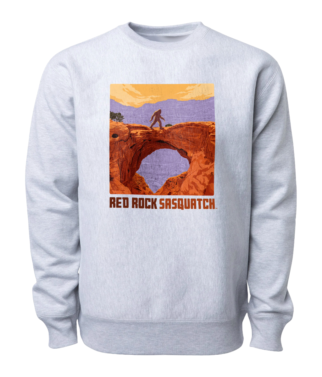 Heather Gray-colored Capitol Reef crewneck sweatshirt featuring a Sasquatch crossing Hickman Bridge. Perfect for exploring Utah's national parks.