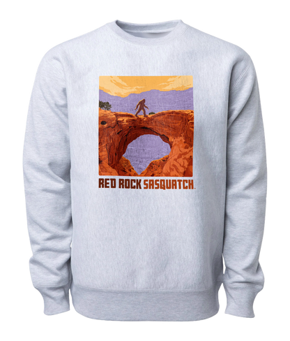 Heather Gray-colored Capitol Reef crewneck sweatshirt featuring a Sasquatch crossing Hickman Bridge. Perfect for exploring Utah's national parks.