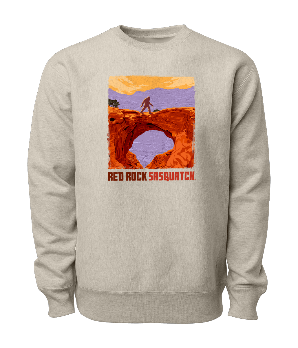 Sand-colored Capitol Reef crewneck sweatshirt featuring a Sasquatch crossing Hickman Bridge. Perfect for exploring Utah's national parks.