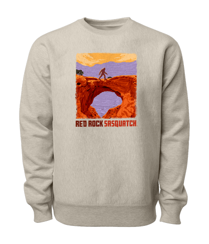 Sand-colored Capitol Reef crewneck sweatshirt featuring a Sasquatch crossing Hickman Bridge. Perfect for exploring Utah's national parks.