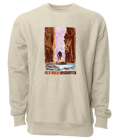 This sand-colored crewneck sweatshirt showcases a Sasquatch wading through The Narrows in Zion National Park. Ideal for outdoor adventures and casual wear.