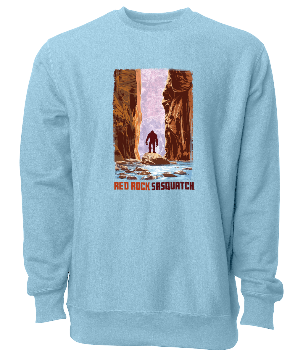 This sky blue crewneck sweatshirt captures the beauty of The Narrows in Zion National Park, with a Sasquatch adding a touch of mystery.