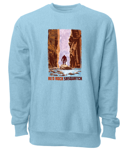 This sky blue crewneck sweatshirt captures the beauty of The Narrows in Zion National Park, with a Sasquatch adding a touch of mystery.