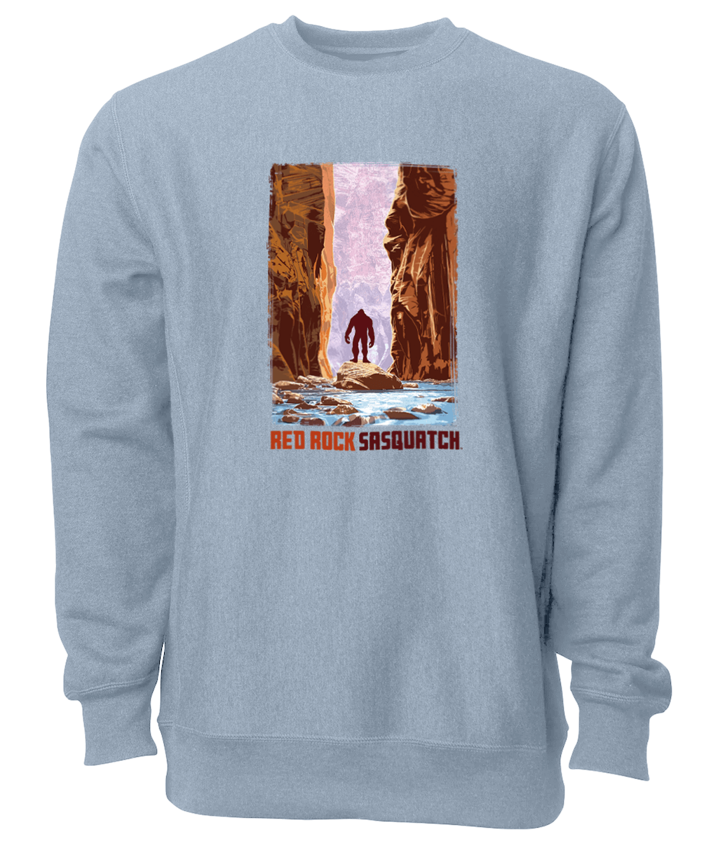 Embrace the adventurous spirit of Zion National Park with this stone blue crewneck sweatshirt featuring a Sasquatch in The Narrows.